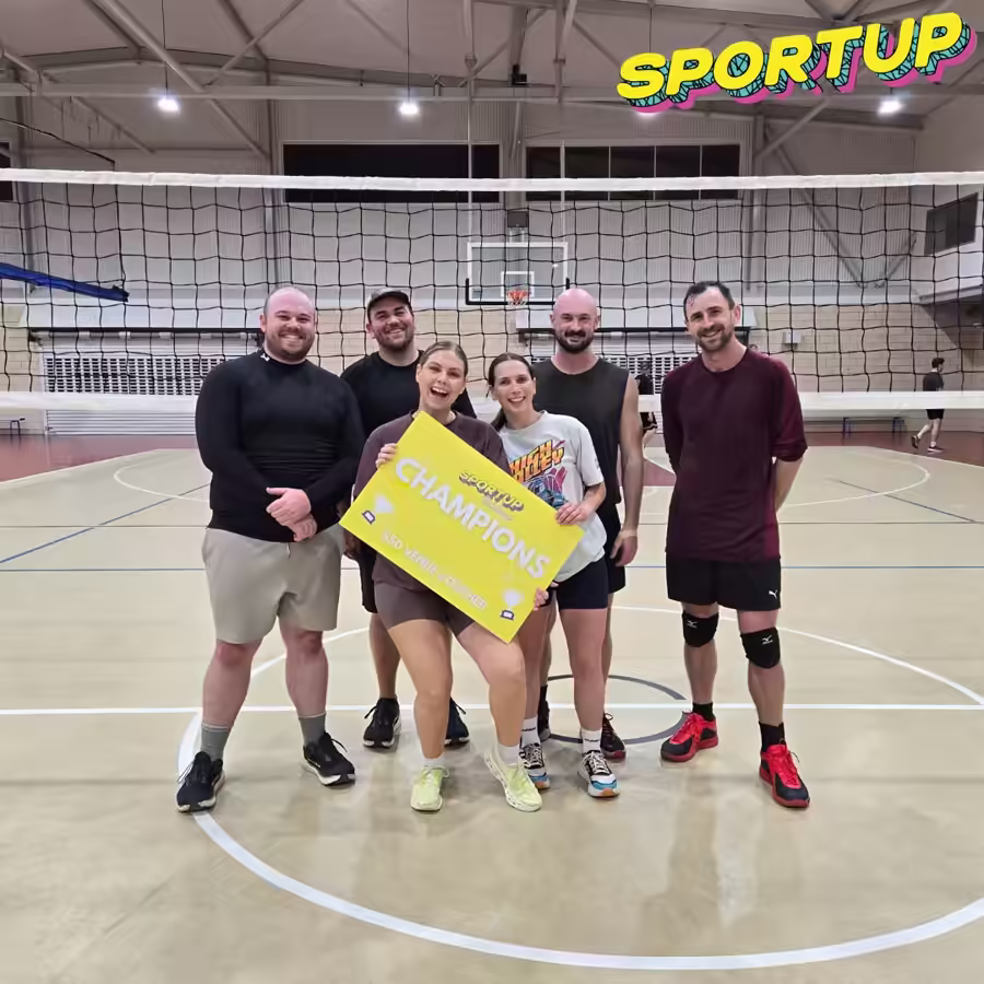 SportUP volleyball champions celebrating with their winners sign